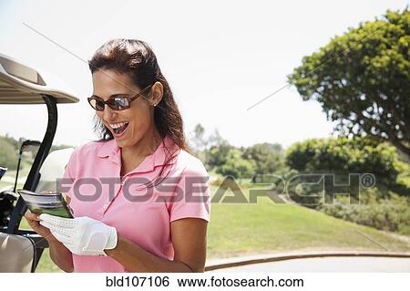 Woman keeping score during golf game View Large Photo Image Stock Photograph - Woman keeping score during golf game. Fotosearch