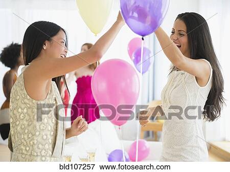 Women playing with balloons at party View Large Photo Image Stock Photo - Women playing with balloons at party. Fotosearch