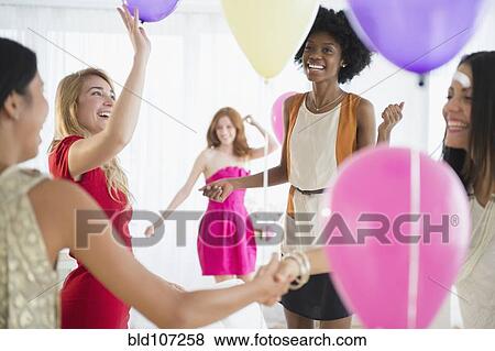 Women playing with balloons at party View Large Photo Image Stock Photo - Women playing with balloons at party. Fotosearch