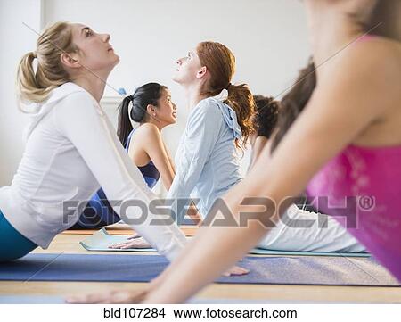 Women practicing yoga in class View Large Photo Image Picture - Women practicing yoga in class. Fotosearch