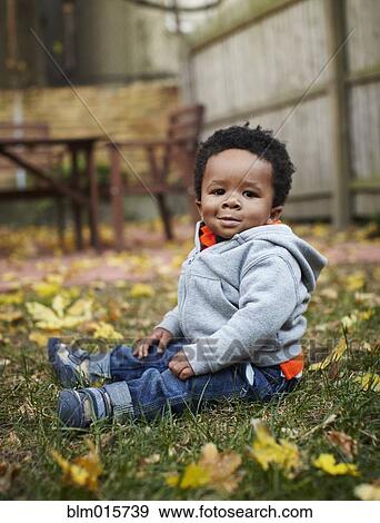 African American baby sitting in grass View Large Photo Image Stock Photo - African American baby sitting in grass. Fotosearch