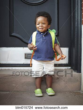 Picture - African American baby wearing backpack. Fotosearch
