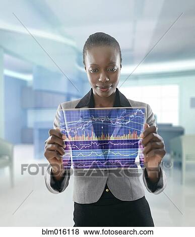 Stock Photo - African American businesswoman using digital display. Fotosearch