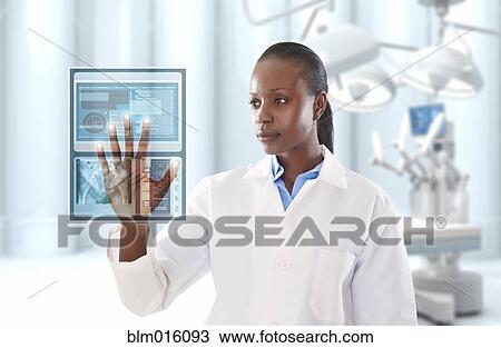 African American doctor looking at digital display in doctor's office View Large Photo Image Stock Image - African American doctor looking at digital display in doctor's office. Fotosearch