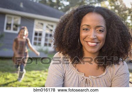 African American mother and daughter in backyard View Large Photo Image Stock Photo - African American mother and daughter in backyard. Fotosearch