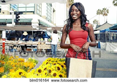 African American woman buying flowers View Large Photo Image Picture - African American woman buying flowers. Fotosearch
