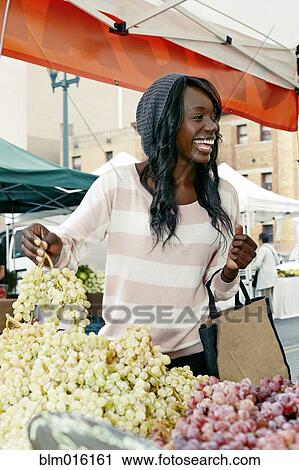 African American woman buying grapes View Large Photo Image Stock Image - African American woman buying grapes. Fotosearch