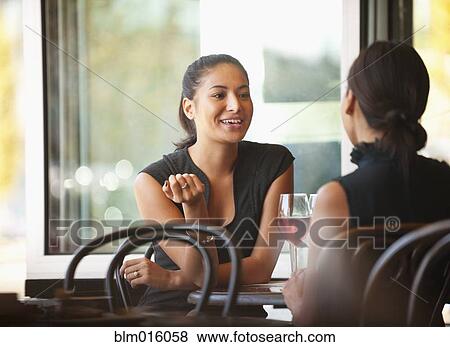 Asian friends sitting together in cafe View Large Photo Image Stock Photo - Asian friends sitting together in cafe. Fotosearch