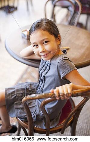 Asian girl sitting in cafe View Large Photo Image Stock Photograph - Asian girl sitting in cafe. Fotosearch