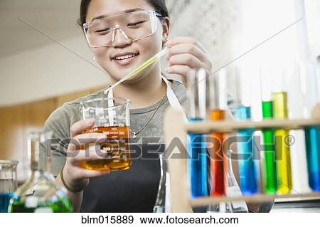 Asian student working with chemicals in classroom View Large Photo Image Stock Photo - Asian student working with chemicals in classroom. Fotosearch