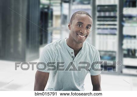 Stock Image - Black businessman in server room. Fotosearch
