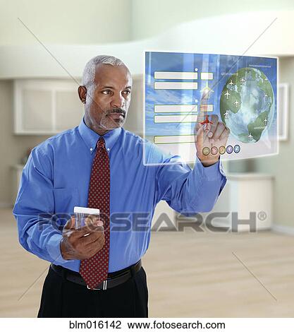Black businessman using digital display in office View Large Photo Image Stock Image - Black businessman using digital display in office. Fotosearch
