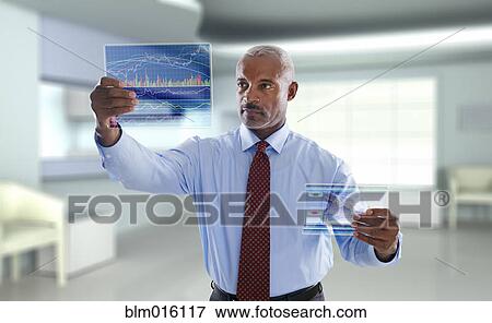 Stock Photo - Black businessman using digital display. Fotosearch