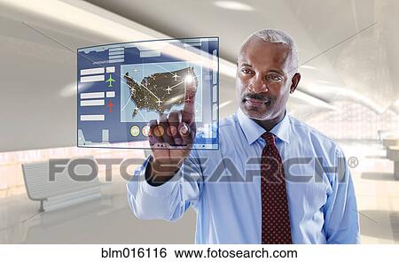 Stock Photograph - Black businessman using digital display. Fotosearch
