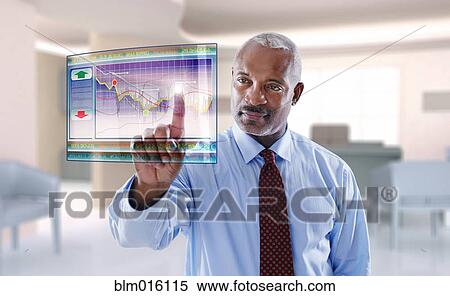 Stock Photography - Black businessman using digital display. Fotosearch