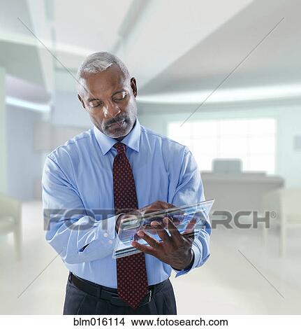 Black businessman using digital tablet View Large Photo Image Picture - Black businessman using digital tablet. Fotosearch