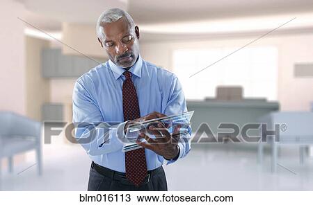 Black businessman using digital tablet View Large Photo Image Stock Image - Black businessman using digital tablet. Fotosearch