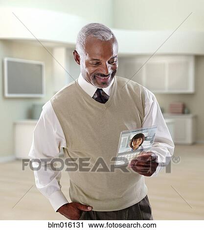 Black businessman using digital tablet in office View Large Photo Image Stock Image - Black businessman using digital tablet in office. Fotosearch