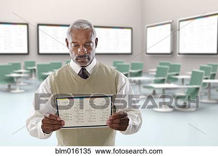 Black businessman using digital tablet in conference room View Large Photo Image Stock Photography - Black businessman using digital tablet in conference room. Fotosearch