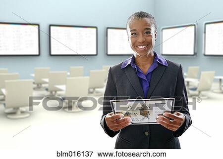 Stock Photo - Black businesswoman using digital tablet in conference room. Fotosearch