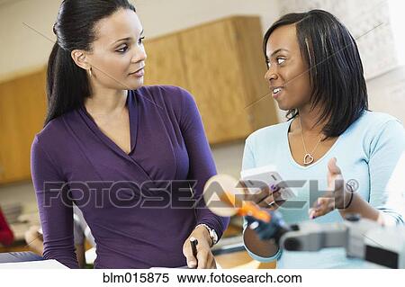 Black high school teacher talking to student in classroom View Large Photo Image Stock Photography - Black high school teacher talking to student in classroom. Fotosearch