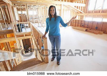 Black woman standing in unfinished room View Large Photo Image Stock Photo - Black woman standing in unfinished room. Fotosearch