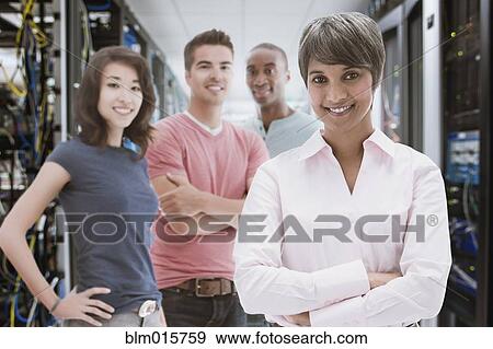 Stock Photo - Business people standing in server room. Fotosearch