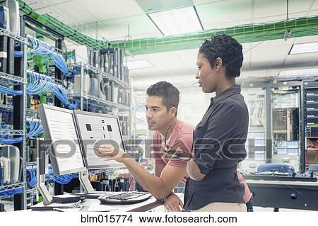 Business people working in server room View Large Photo Image Picture - Business people working in server room. Fotosearch