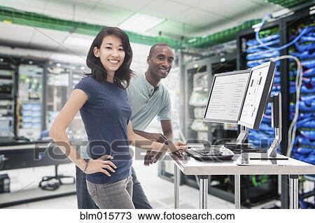Business people working in server room View Large Photo Image Stock Image - Business people working in server room. Fotosearch