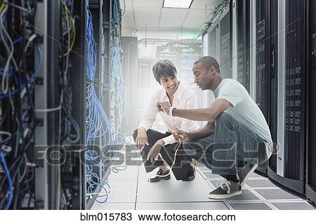 Business people working in server room View Large Photo Image Stock Image - Business people working in server room. Fotosearch