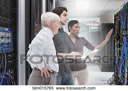 Business people working in server room View Large Photo Image Stock Photography - Business people working in server room. Fotosearch
