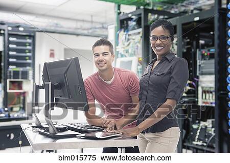 Business people working in server room View Large Photo Image Stock Photography - Business people working in server room. Fotosearch