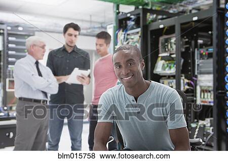 Stock Photo - Businessmen in server room. Fotosearch