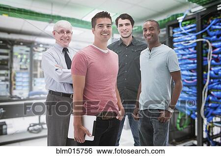 Stock Photograph - Businessmen standing in server room. Fotosearch