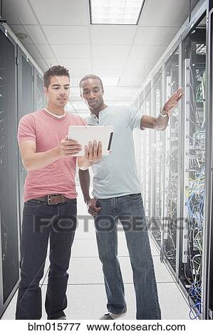 Stock Photo - Businessmen working in server room. Fotosearch
