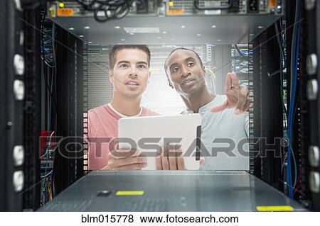 Stock Photo - Businessmen working in server room. Fotosearch