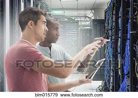 Stock Photo - Businessmen working in server room. Fotosearch