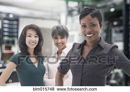 Businesswomen standing in server room View Large Photo Image Stock Photo - Businesswomen standing in server room. Fotosearch