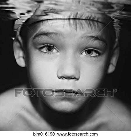 Stock Image - Caucasian boy swimming under water. Fotosearch
