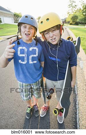 Caucasian boys standing together with skateboards View Large Photo Image Stock Image - Caucasian boys standing together with skateboards. Fotosearch