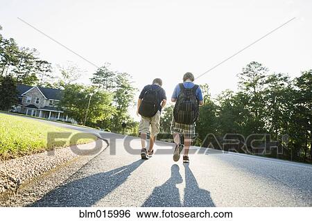 Caucasian boys walking in road View Large Photo Image Stock Photograph - Caucasian boys walking in road. Fotosearch