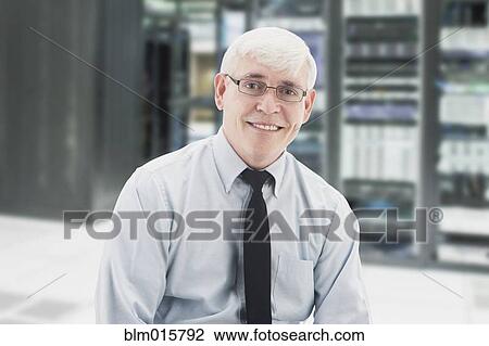 Stock Image - Caucasian businessman in server room. Fotosearch