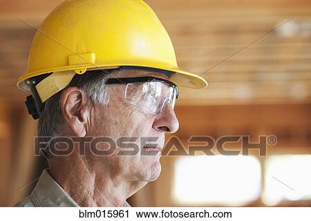 Caucasian construction worker in hard-hat and safety glasses View Large Photo Image Stock Image - Caucasian construction worker in hard-hat and safety glasses. Fotosearch