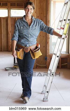 Caucasian construction worker leaning on ladder in unfinished room View Large Photo Image Stock Photo - Caucasian construction worker leaning on ladder in unfinished room. Fotosearch