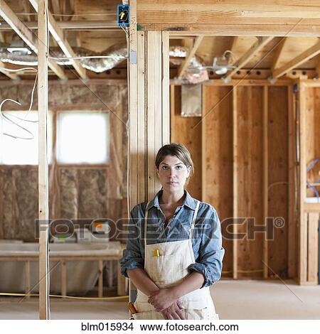 Caucasian construction worker standing in unfinished room View Large Photo Image Picture - Caucasian construction worker standing in unfinished room. Fotosearch