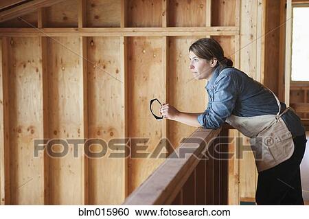 Caucasian construction worker standing in unfinished room View Large Photo Image Stock Image - Caucasian construction worker standing in unfinished room. Fotosearch