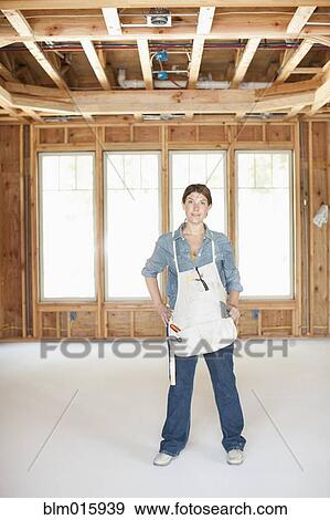 Caucasian construction worker standing in unfinished room View Large Photo Image Stock Photo - Caucasian construction worker standing in unfinished room. Fotosearch