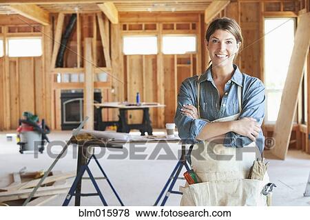 Caucasian construction worker standing in unfinished room View Large Photo Image Stock Photo - Caucasian construction worker standing in unfinished room. Fotosearch