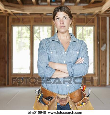 Caucasian construction worker with arms crossed in unfinished room View Large Photo Image Stock Photo - Caucasian construction worker with arms crossed in unfinished room. Fotosearch