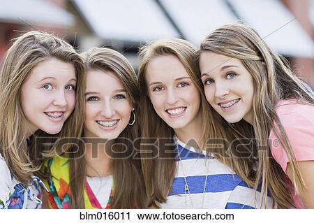 Stock Image - Caucasian friends hanging out together. Fotosearch
